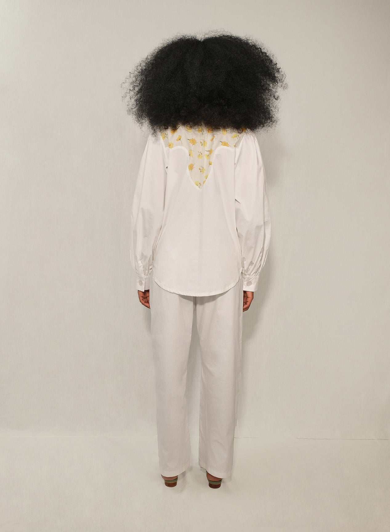 Model wearing women’s western yoke poplin shirt with Mini Daisy floral panel, front view.