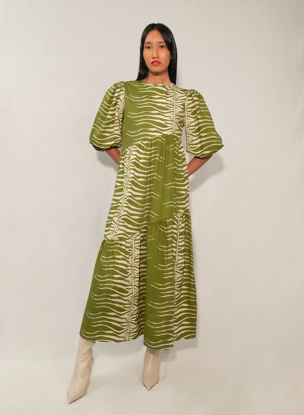 Model wearing puff sleeve tiered midi dress in Green Snake print.
