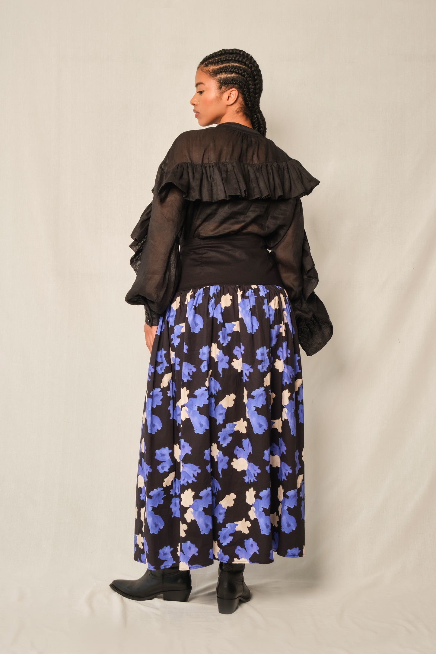 High-neck black linen ruffle blouse with keyhole button and balloon sleeves.