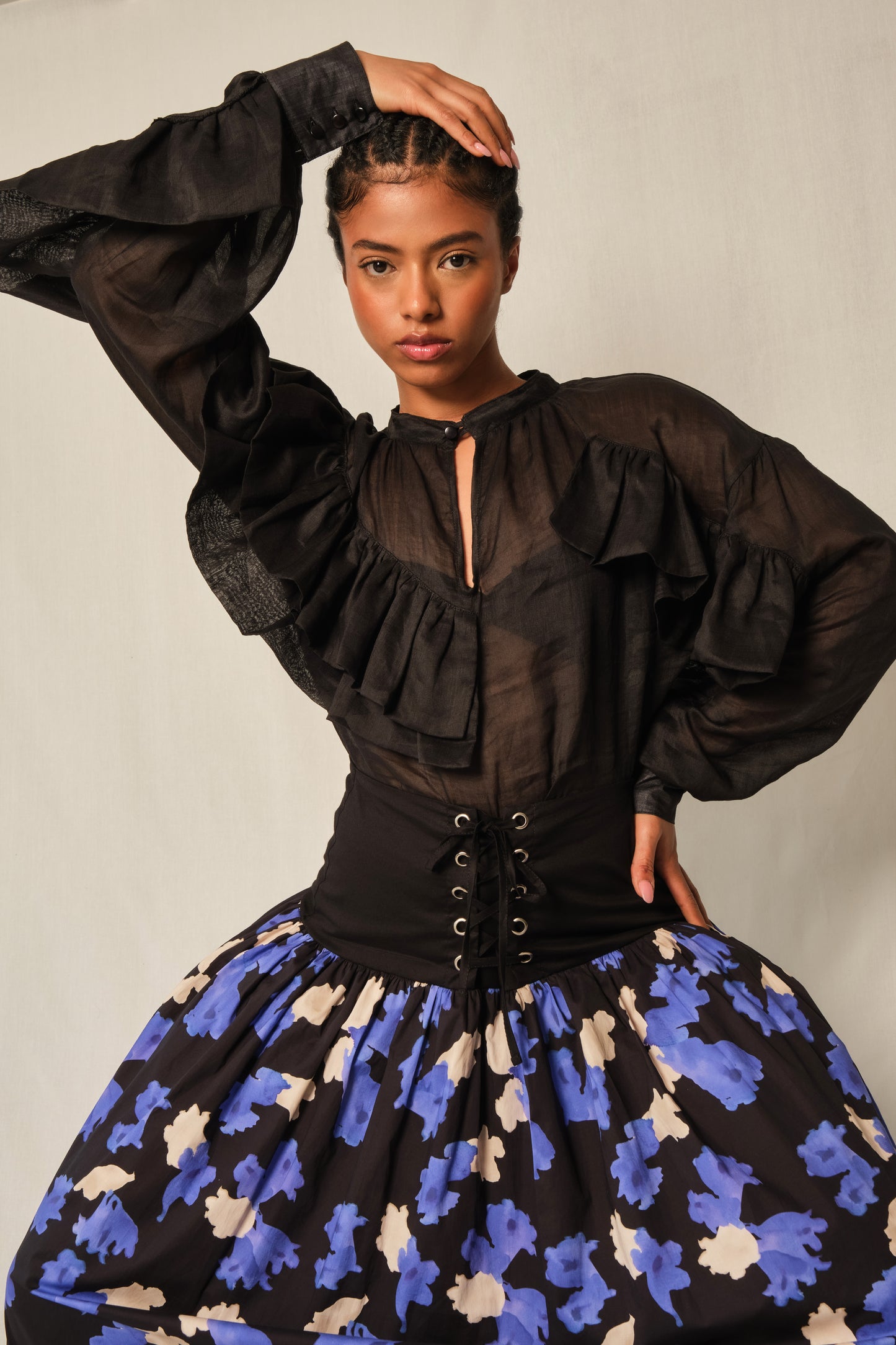 High-neck black linen ruffle blouse with keyhole button and balloon sleeves.