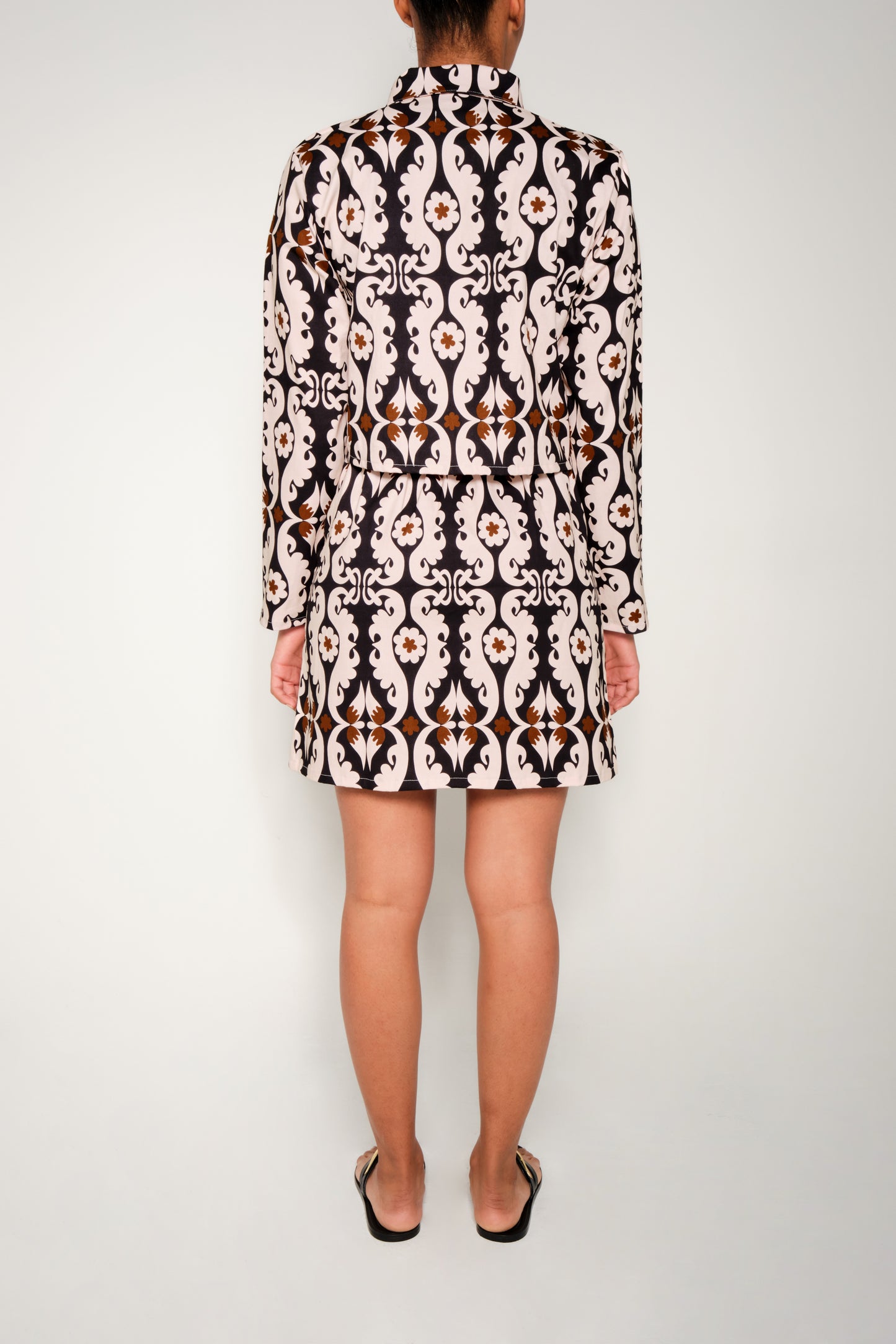 Model wearing cropped paisley jacket in heavy cotton with flap pockets