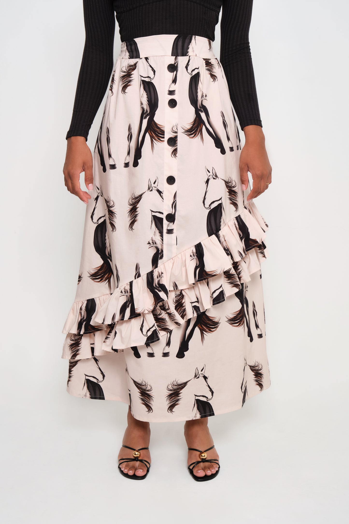 Model wearing asymmetrical ruffle maxi skirt with beige horse print