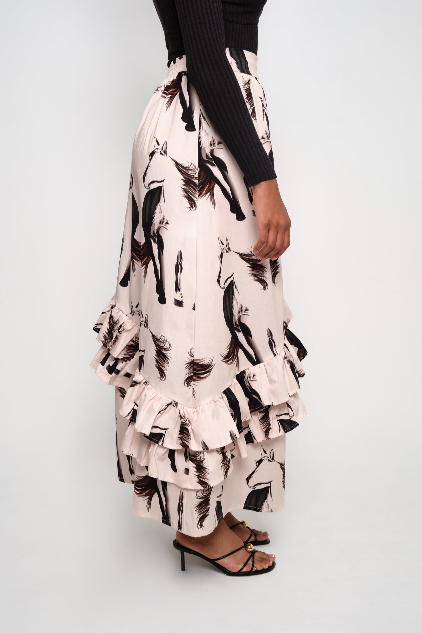 Model wearing asymmetrical ruffle maxi skirt with beige horse print
