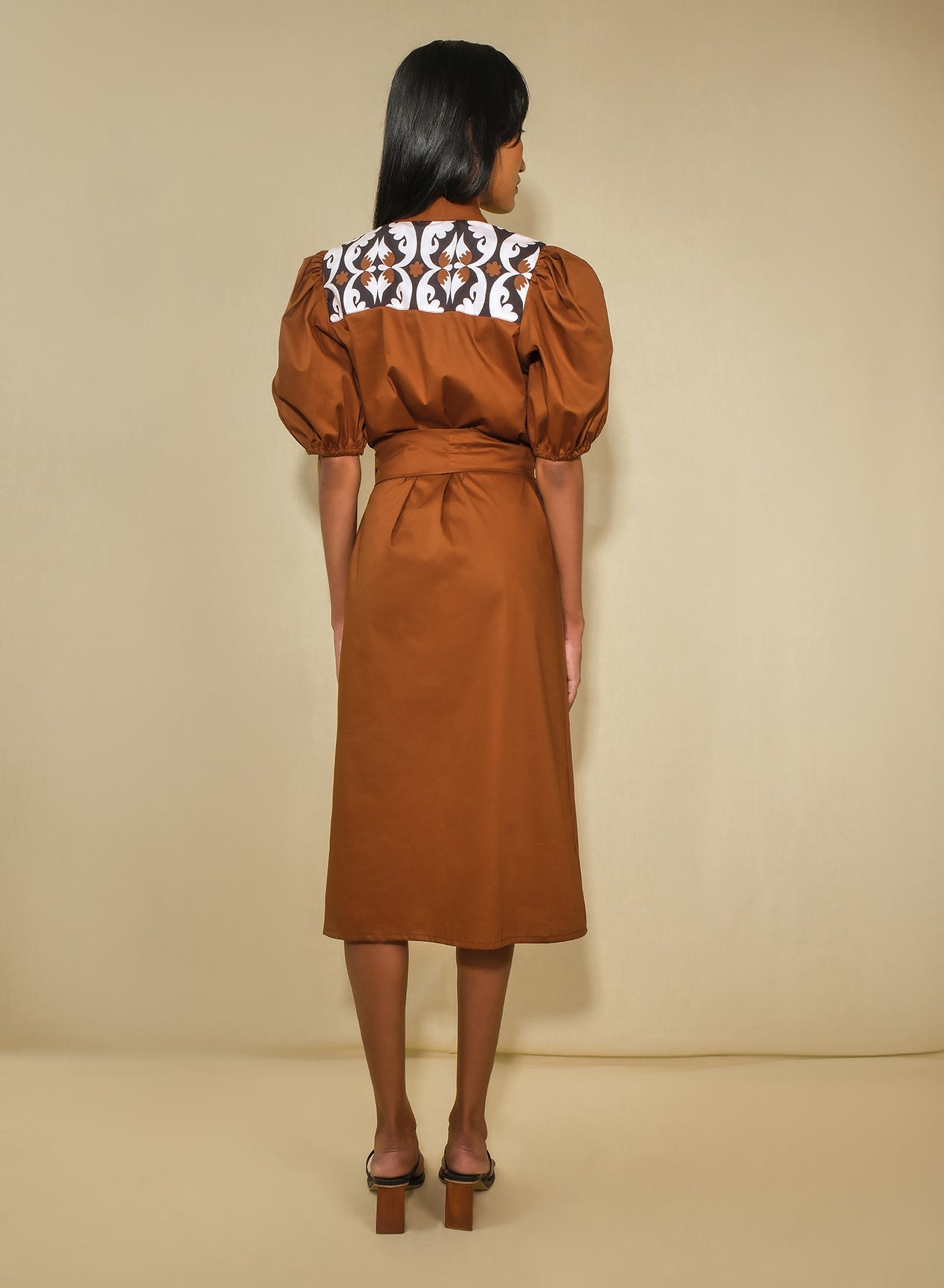 Back of model wearing a puff sleeve midi shirt dress