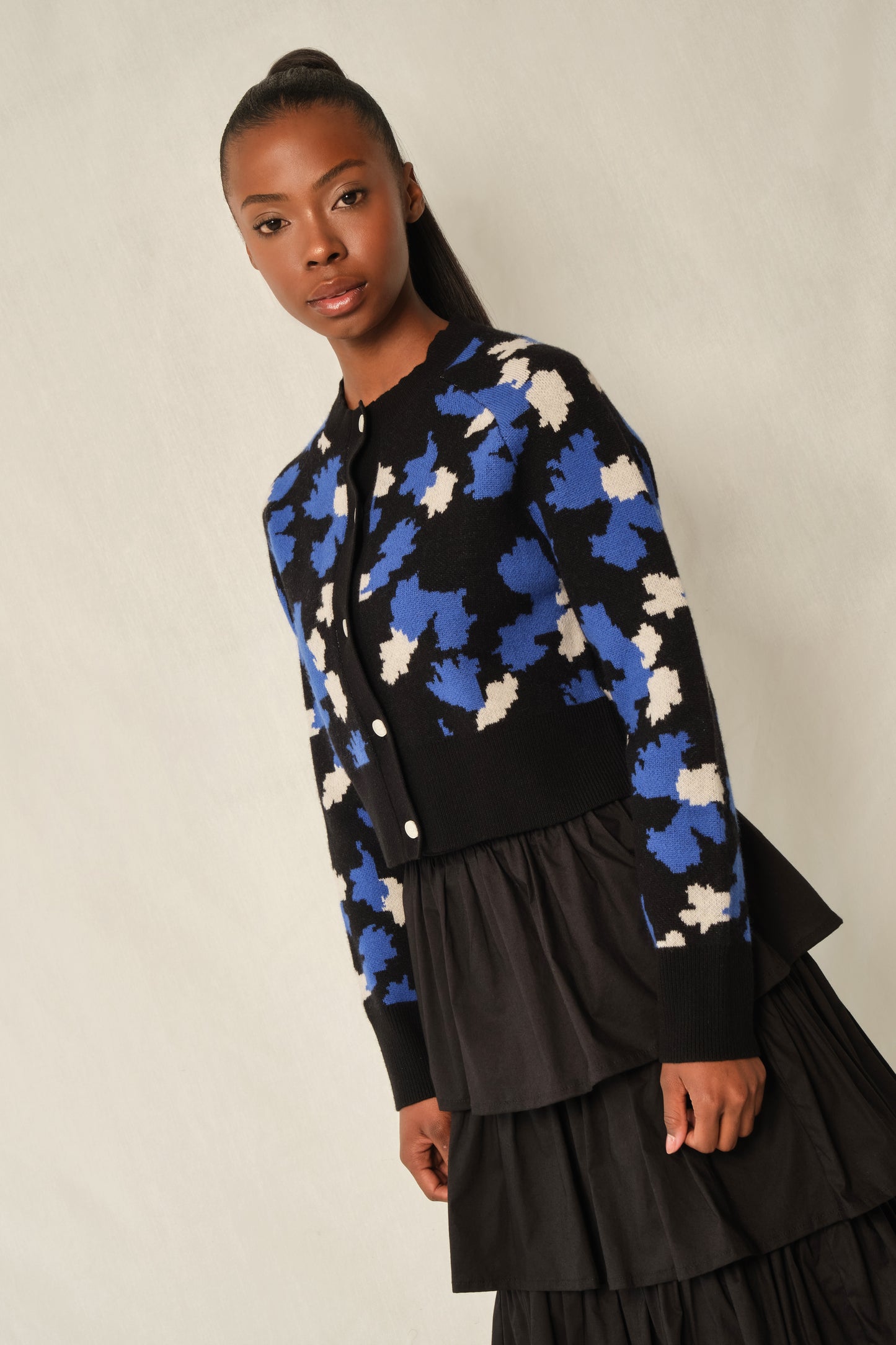 Model wearing black tiered maxi skirt in stretch poplin with elastic back waistband.