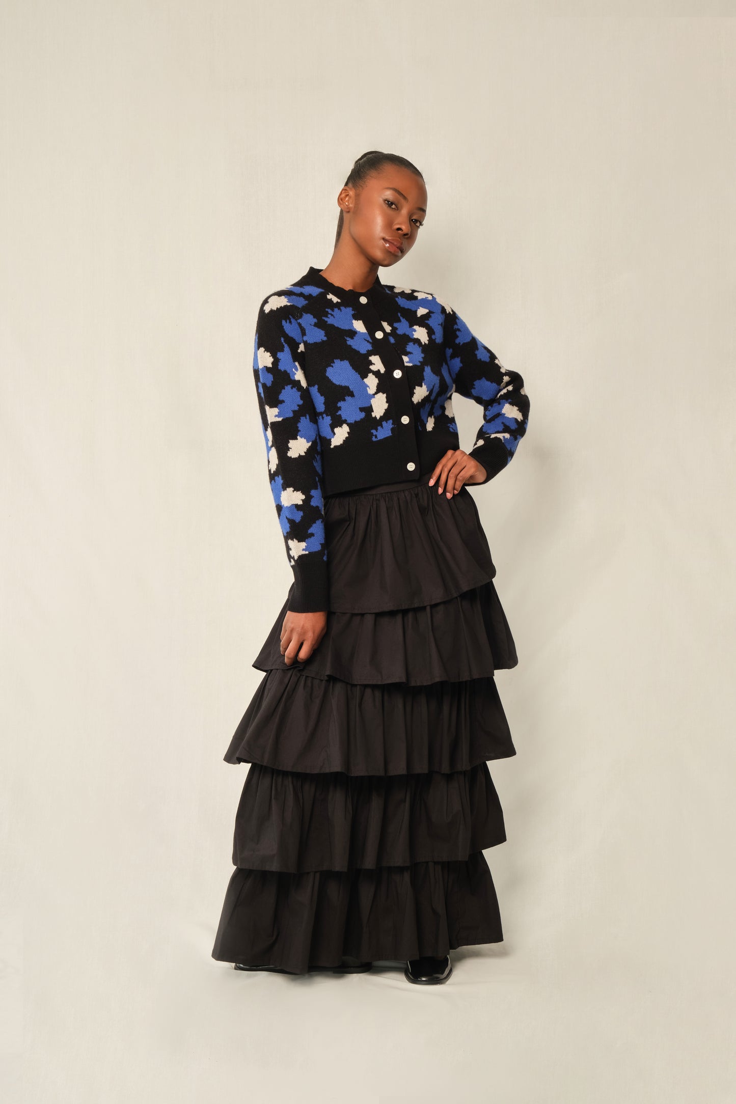 Model wearing black tiered maxi skirt in stretch poplin with elastic back waistband.