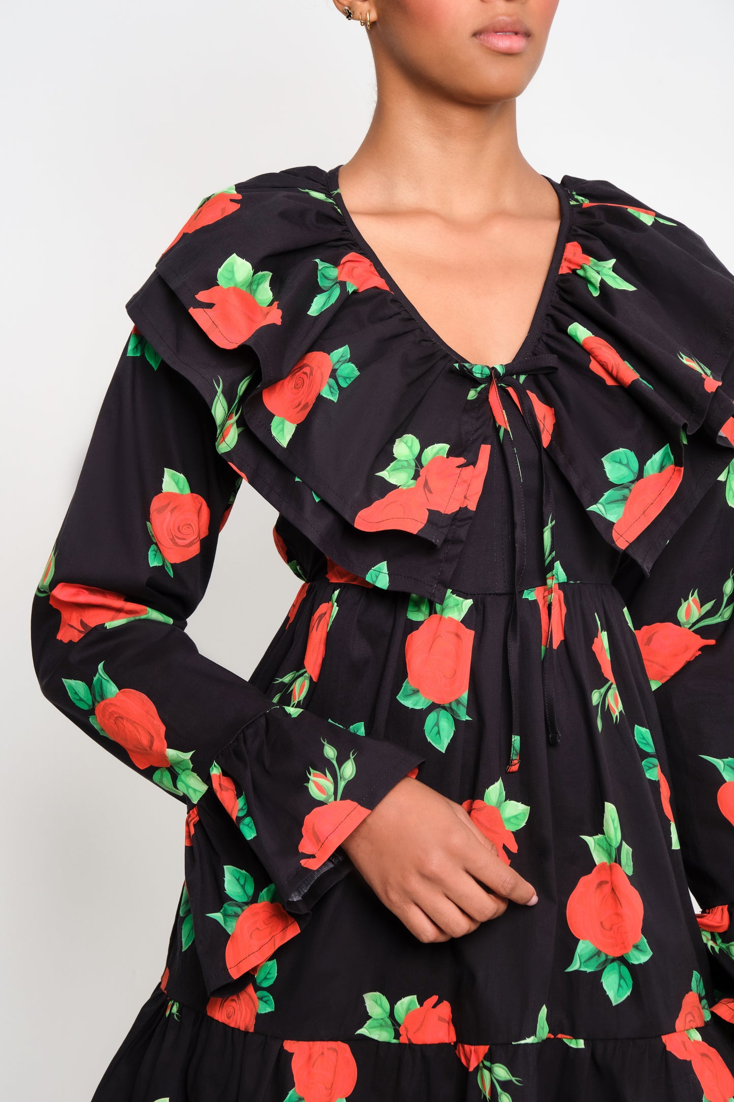 Model wearing tiered poplin mini dress with ruffle collar and Maxi Roses print