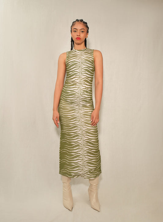 Model wearing sleeveless mesh column midi dress in Green Snake print with back slit.