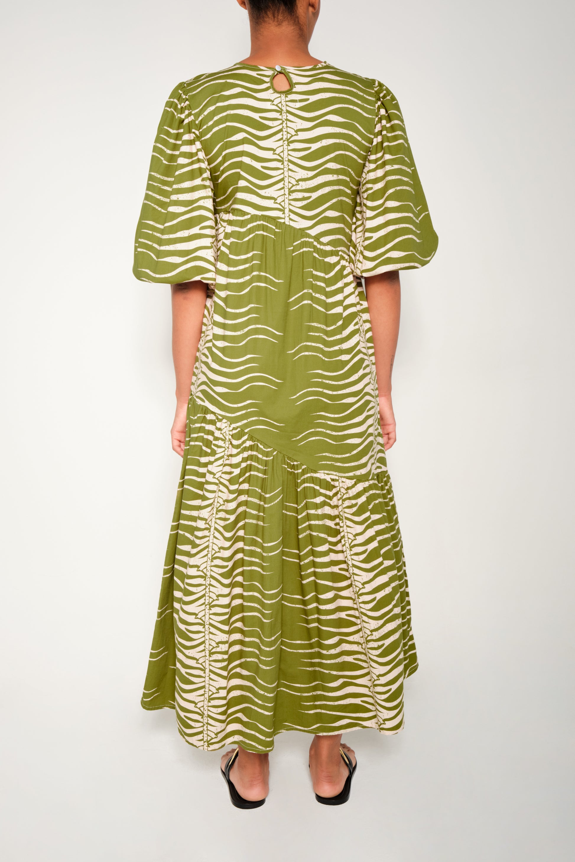Model wearing puff sleeve tiered midi dress in Green Snake print.