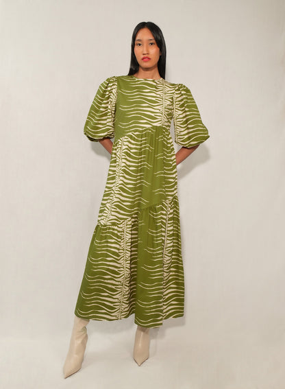 Model wearing puff sleeve tiered midi dress in Green Snake print.