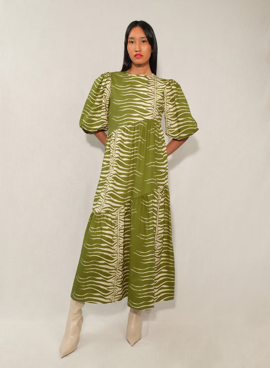 Model wearing puff sleeve tiered midi dress in Green Snake print.