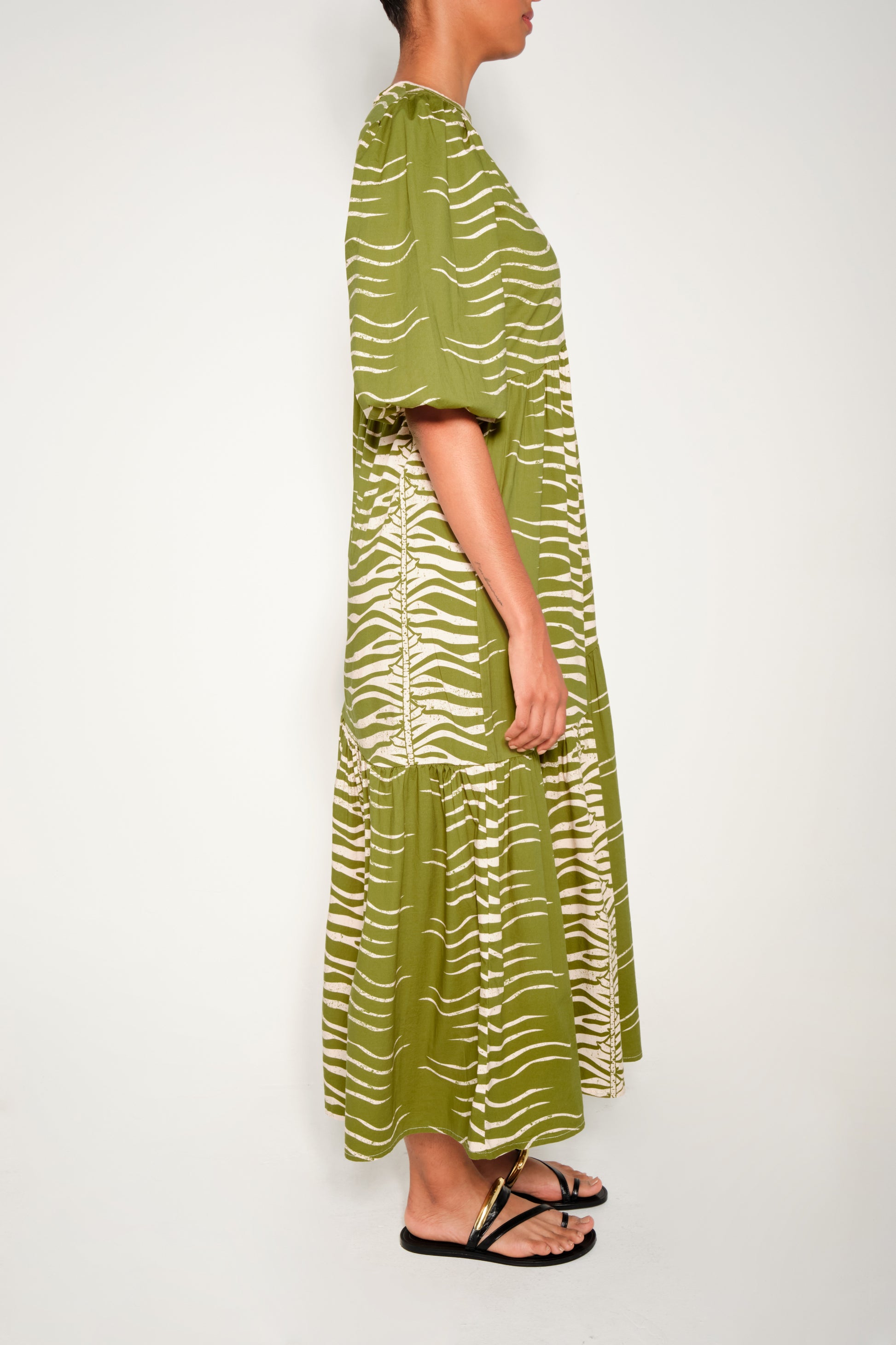Model wearing puff sleeve tiered midi dress in Green Snake print.