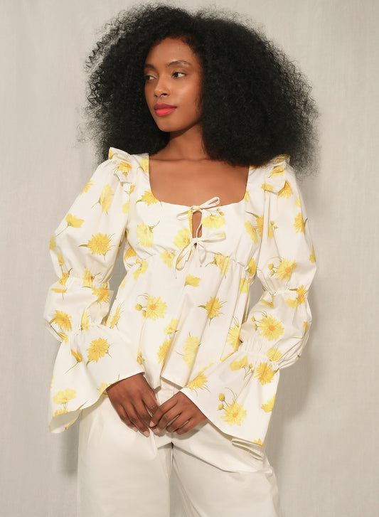Model wearing women’s puff sleeve poplin top with tie-front keyhole in Maxi Daisy print