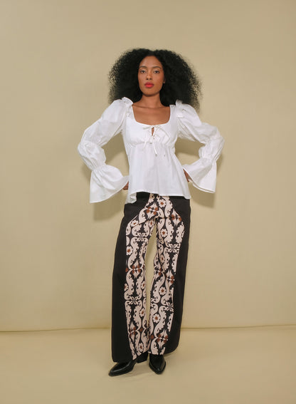 Model wearing high-waisted flared pants with maxi paisley panels