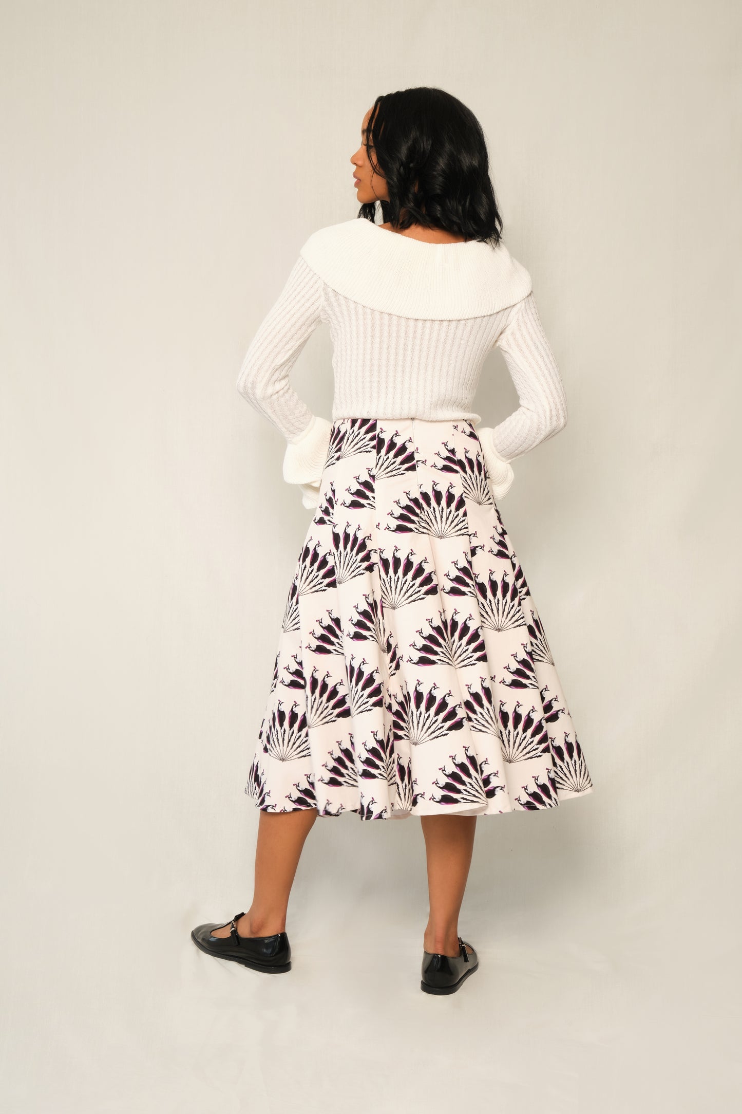Model wearing A-line panel midi skirt in Throated Ivory print with topstitch seams.