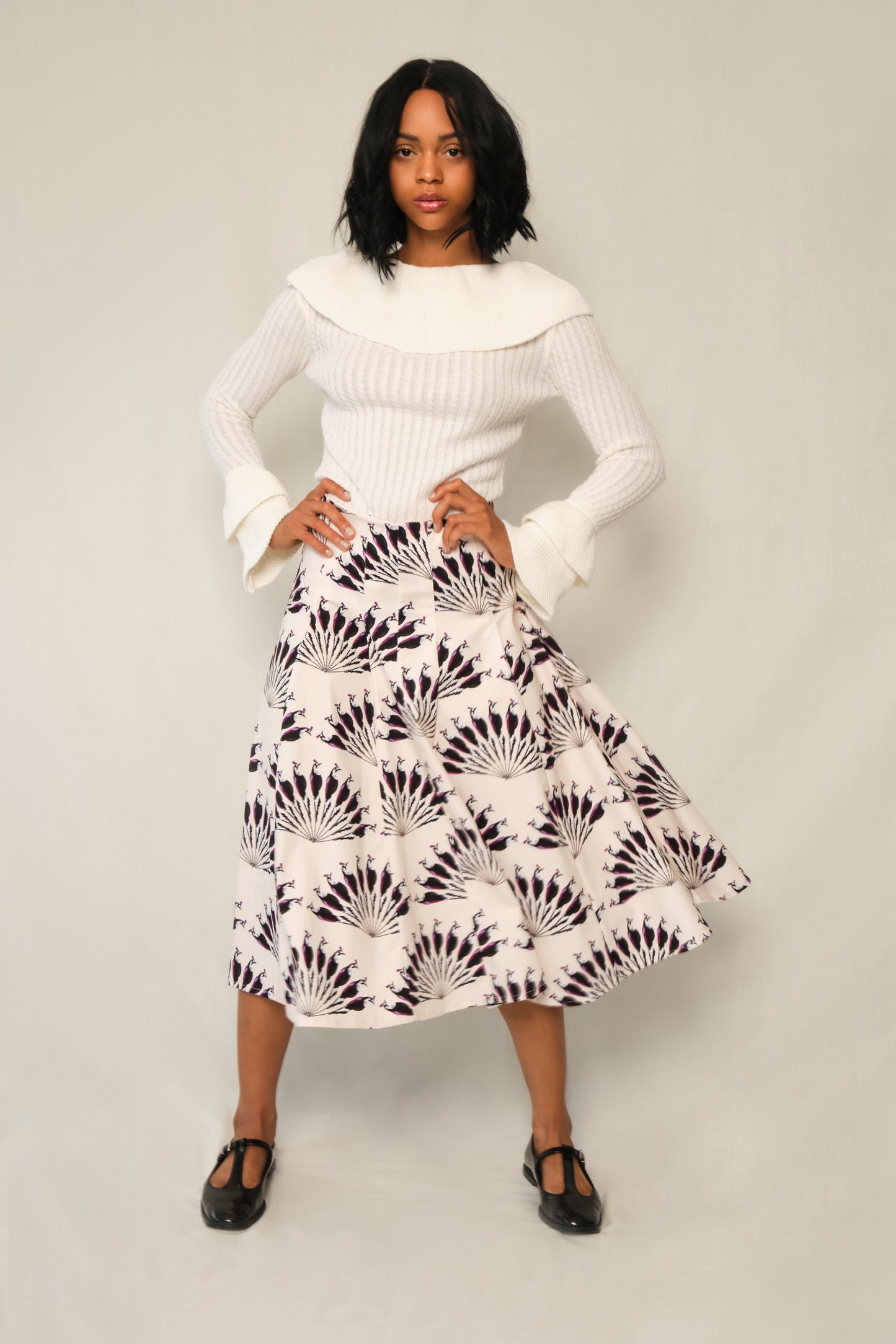 Model wearing A-line panel midi skirt in Throated Ivory print with topstitch seams.