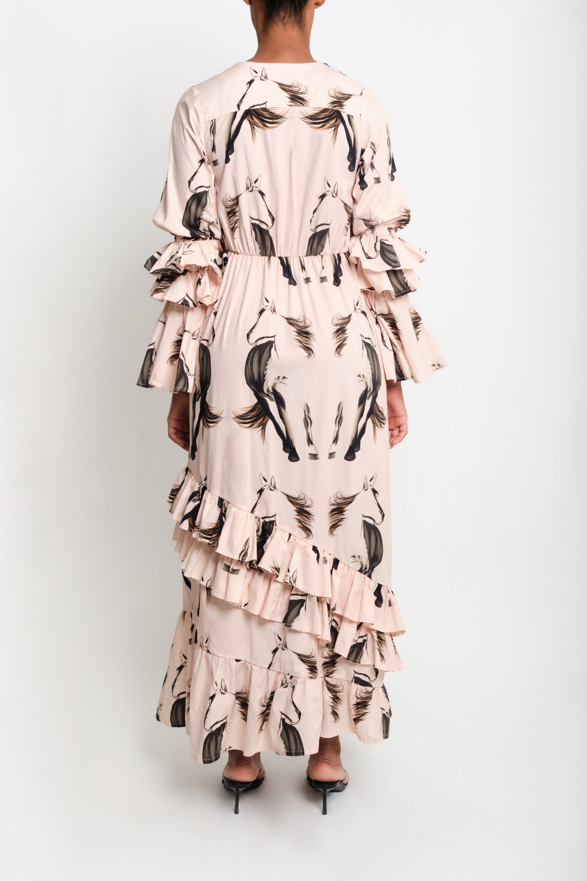 Model wearing horse print poplin maxi shirt dress with ruffle sleeves and asymmetrical tiered skirt