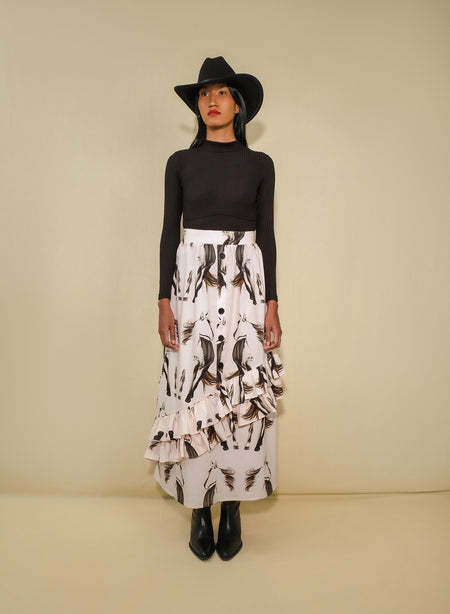 Model wearing asymmetrical ruffle maxi skirt with beige horse print