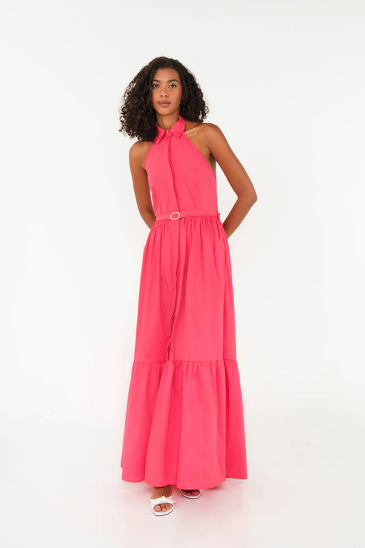 Woman wearing a pink halter neck dress on a white background