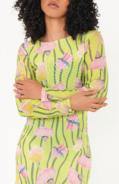 Woman wearing a green dress with pink floral pattern