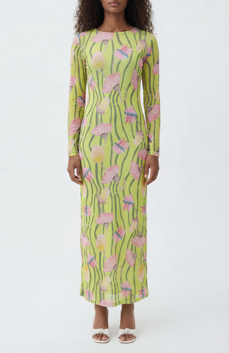 Woman wearing a long-sleeve dress with a floral pattern on a white background