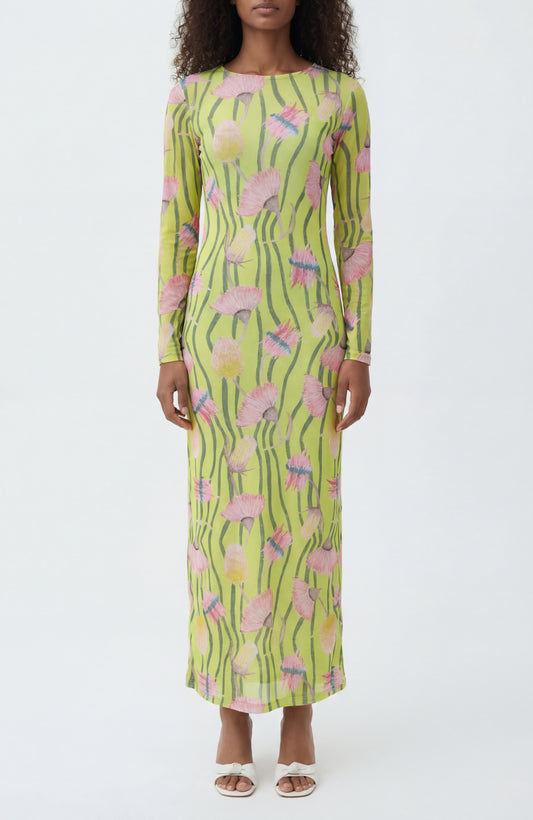 Woman wearing a long-sleeve dress with a floral pattern on a white background