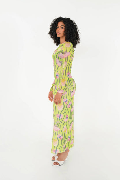 Woman wearing a green floral dress on a white background