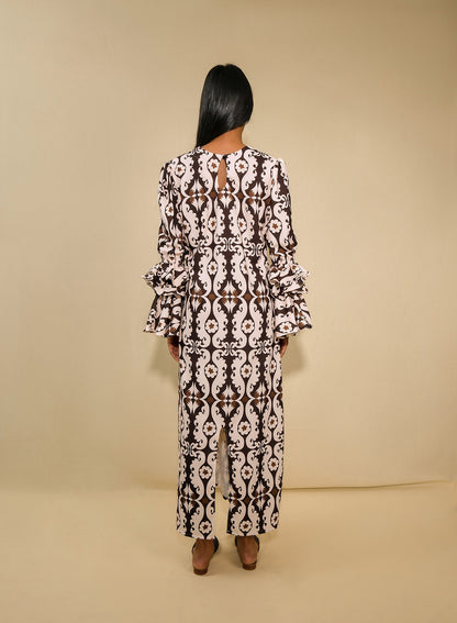 A model wearing a tunic dress with ruffles sleeves and back 