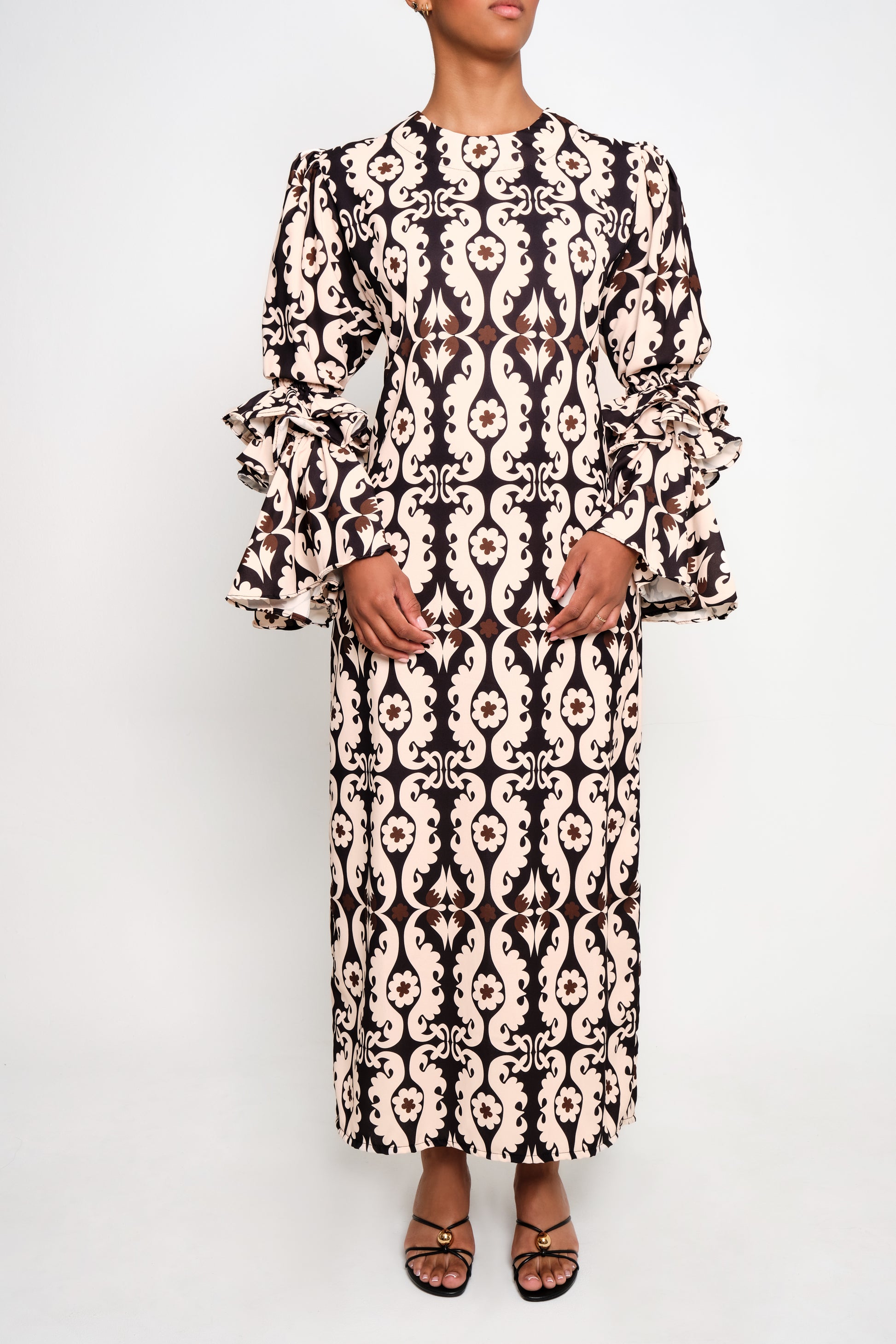 A model wearing tunic dress with ruffle sleeves
