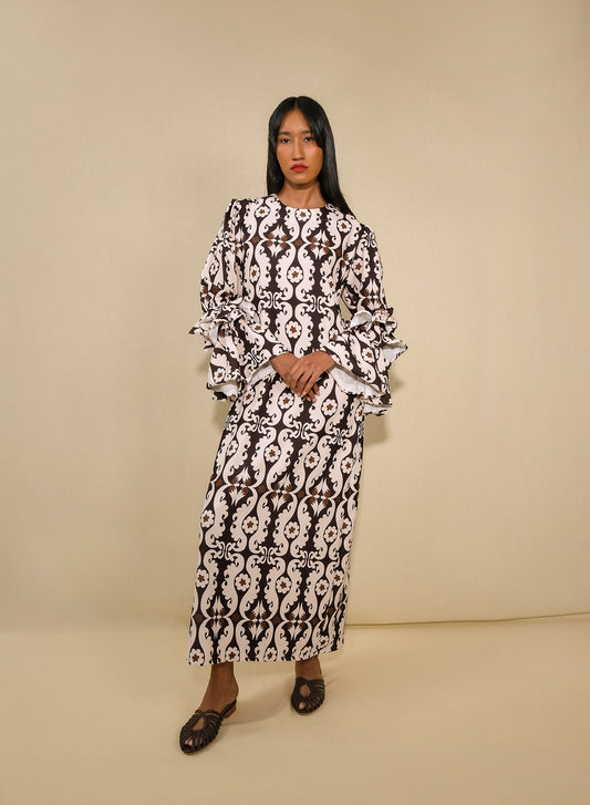 model wearing a tunic dress with ruffle sleeves