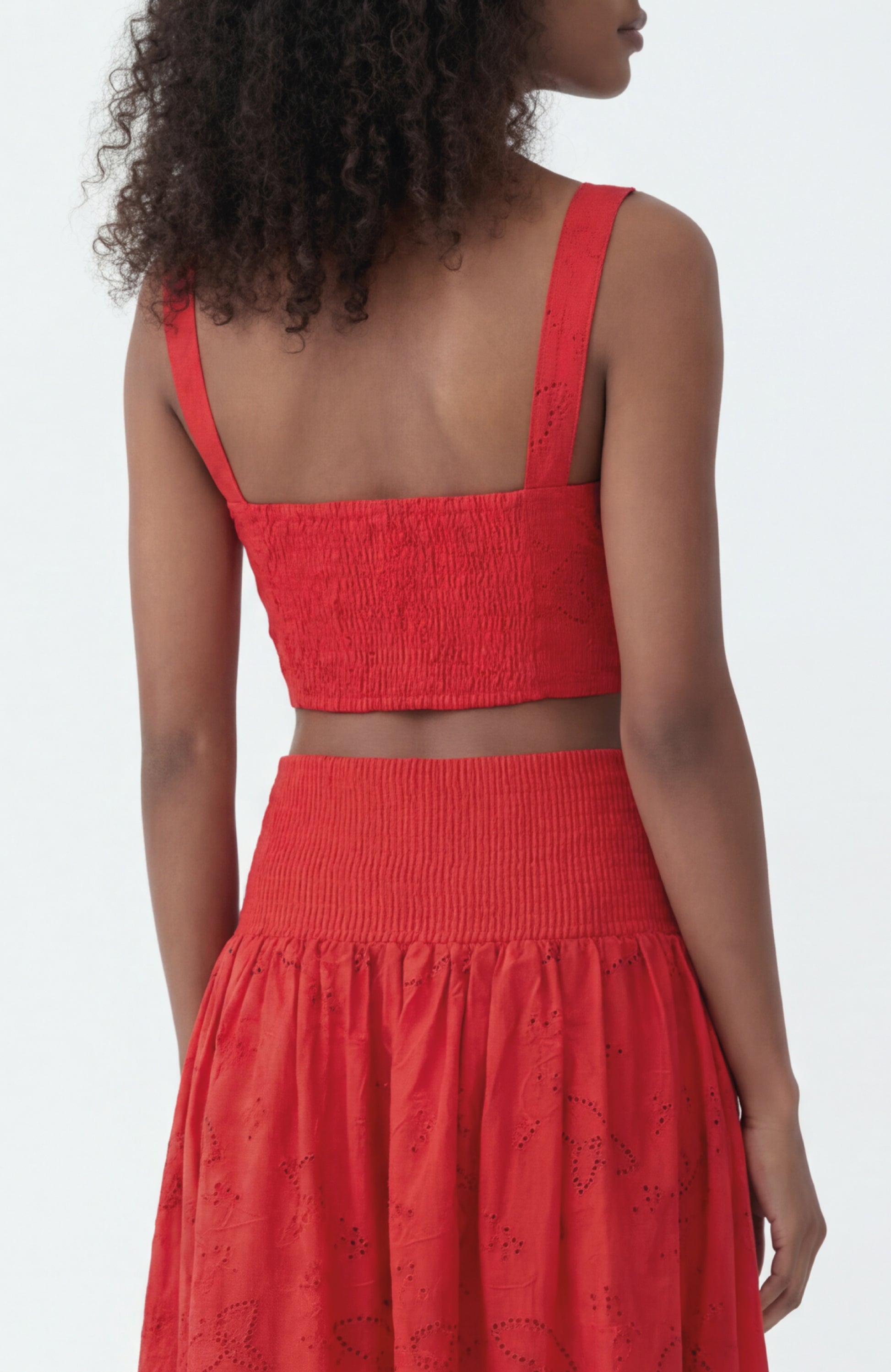 Woman wearing a red dress with a white background