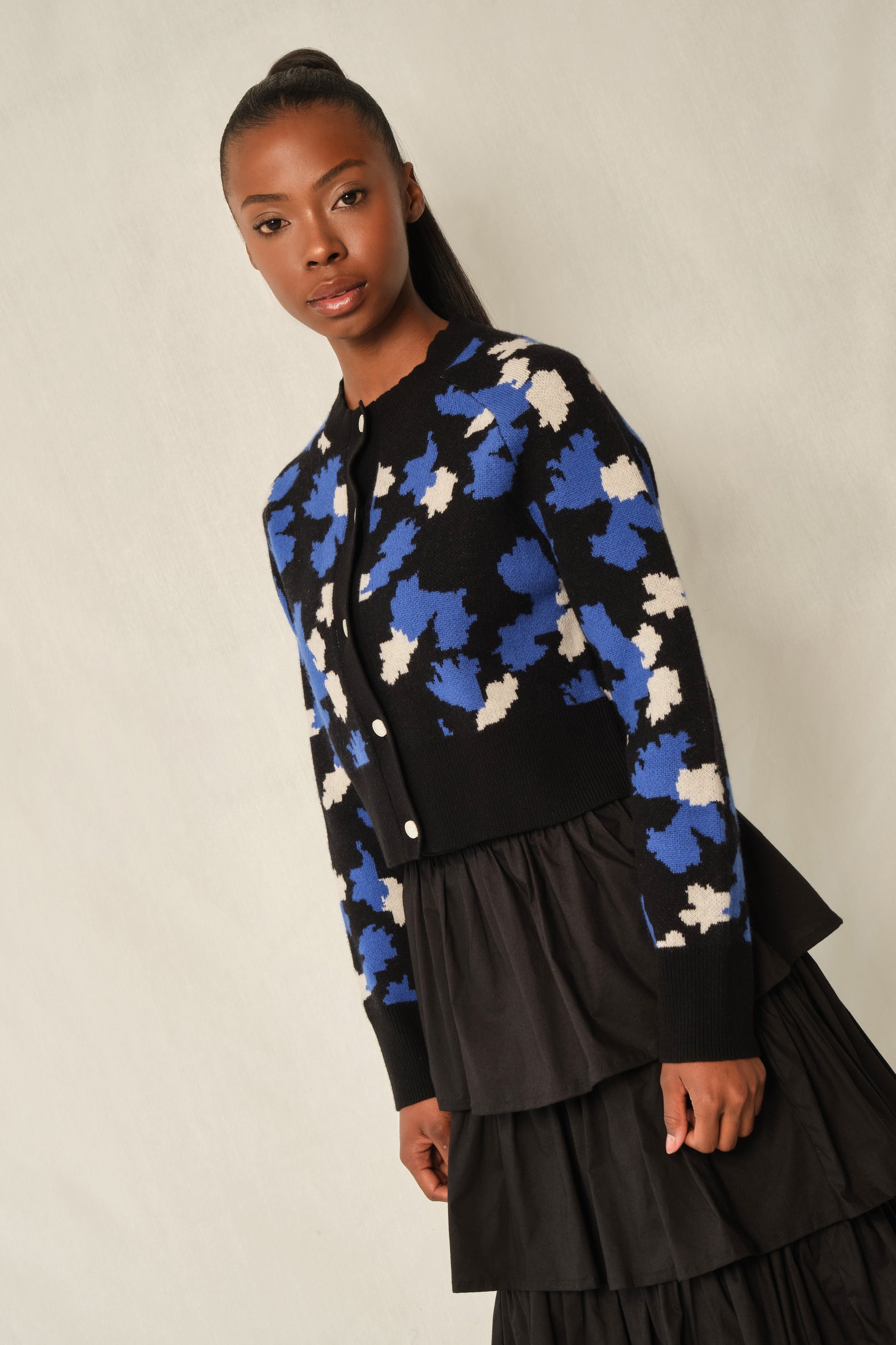 Model wearing black tiered maxi skirt in stretch poplin with elastic back waistband.