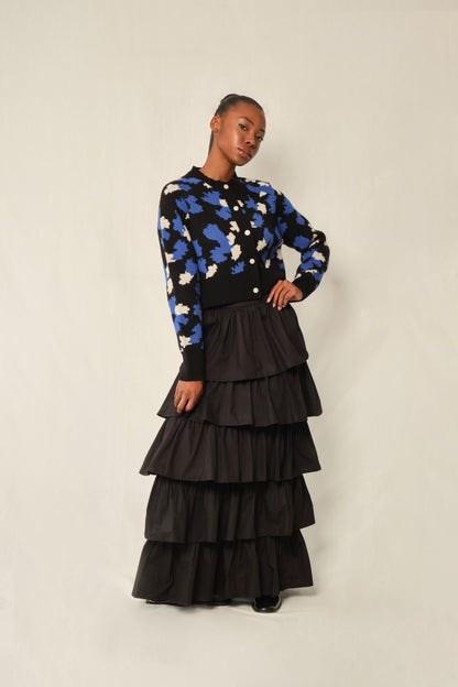 Model wearing black tiered maxi skirt in stretch poplin with elastic back waistband.