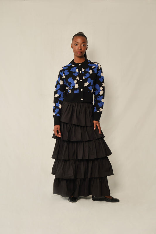 Model wearing black tiered maxi skirt in stretch poplin with elastic back waistband.