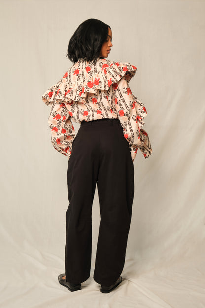 Model wearing high-waisted tapered cotton twill pants with ankle-length hem