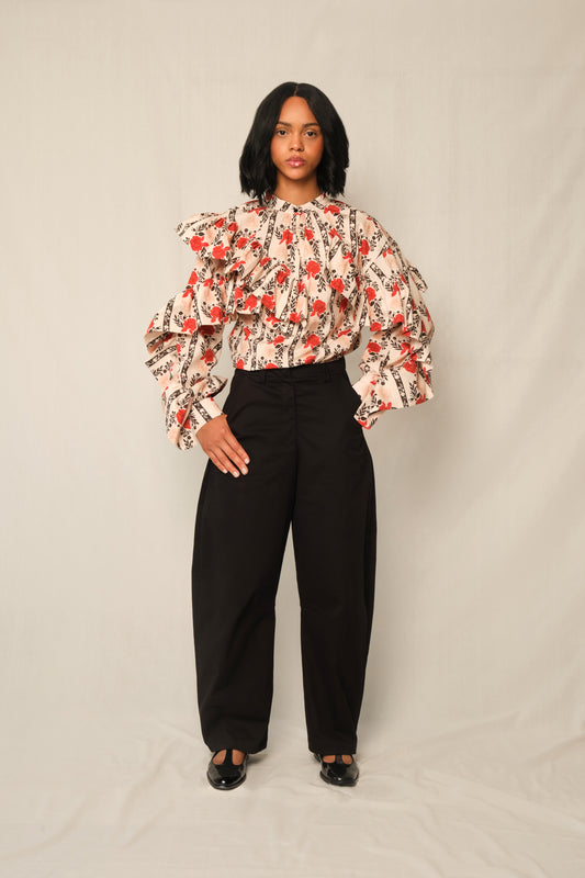 Model wearing high-waisted tapered cotton twill pants with ankle-length hem